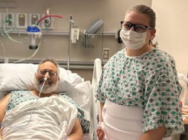 Teacher and patient smiling in hospital bed